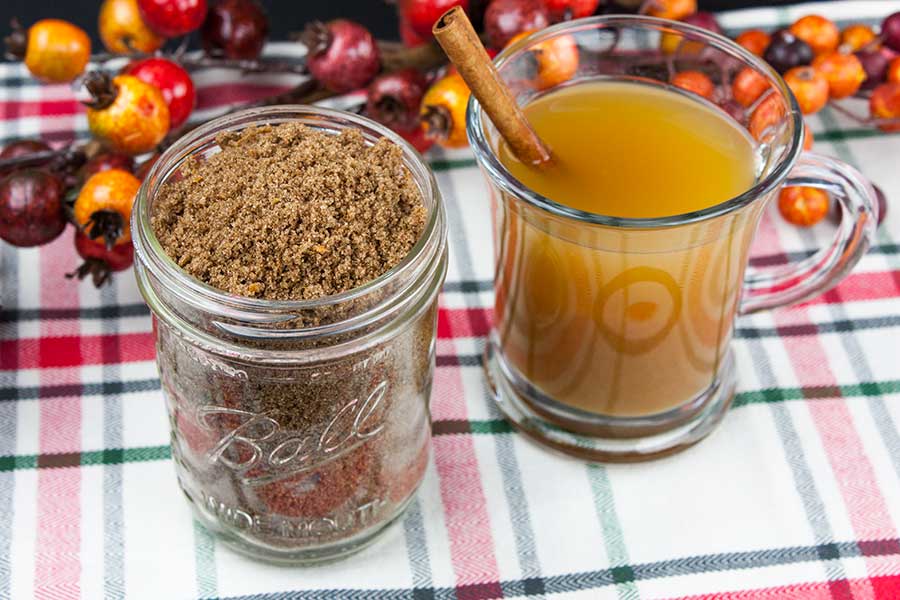 Apple Cider Spice Mix - closeup of the spice mix in a mason jar with a glass mug of hot apple cider next to it