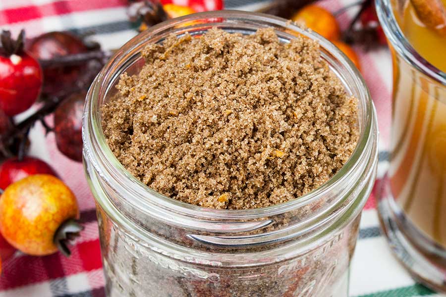 Apple Cider Spice Mix - closeup of the spice mix in a mason jar with a glass mug of hot apple cider next to it