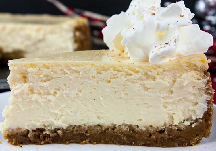 Eggnog Cheesecake with Gingersnap Crust - Thick, rich, creamy, and full of classic eggnog flavor! This recipe features the traditional warm spice flavors of the holidays. A perfect way to indulge during the season!