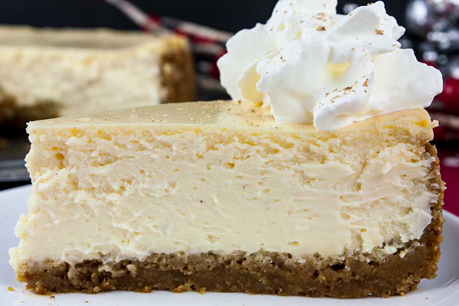 Eggnog Cheesecake with Gingersnap Crust - Thick, rich, creamy, and full of classic eggnog flavor! This recipe features the traditional warm spice flavors of the holidays. A perfect way to indulge during the season!
