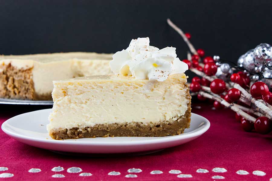 A slice of eggnog cheesecake in a white plate.