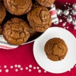 Gingerbread muffins in a basket lined with red, white, and green towel.