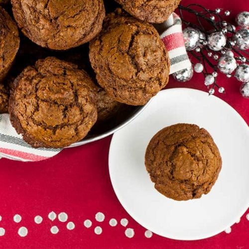 Gingerbread muffins in a basket lined with red, white, and green towel.