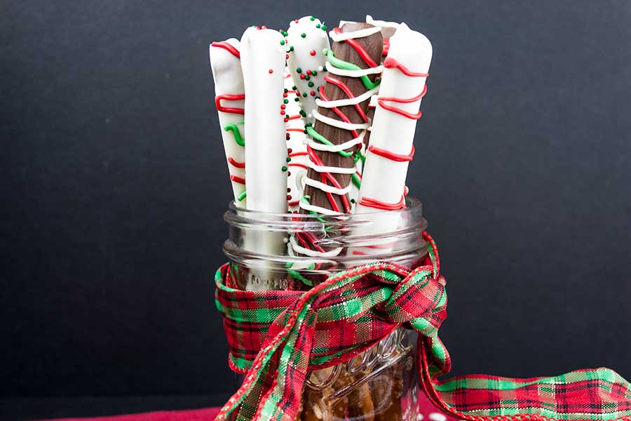 Chocolate Covered Pretzel Rods - chocolate dipped and decorated pretzel rods standing up in a mason jar