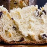 Panettone on a wooden cutting board.