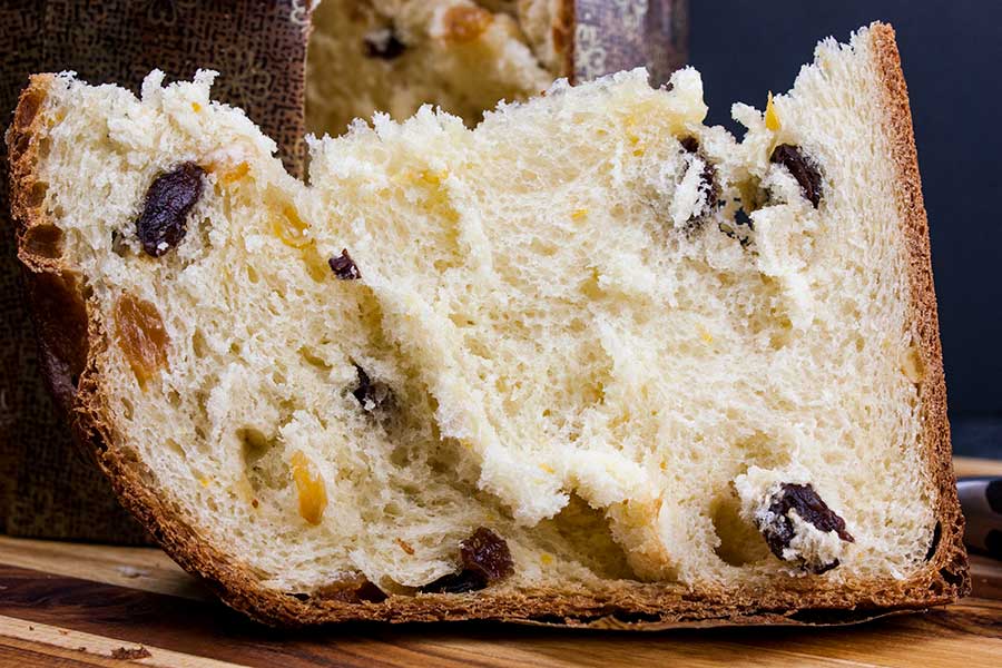 Panettone on a wooden cutting board.