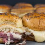 Pastrami and swiss cheese sliders close up.