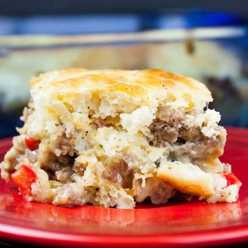 Sausage breakfast cake on a red plate.