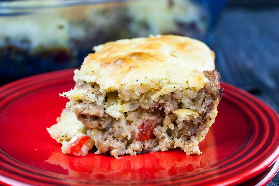 Sausage Breakfast Cake Recipe - serving of the sausage cake on red plate