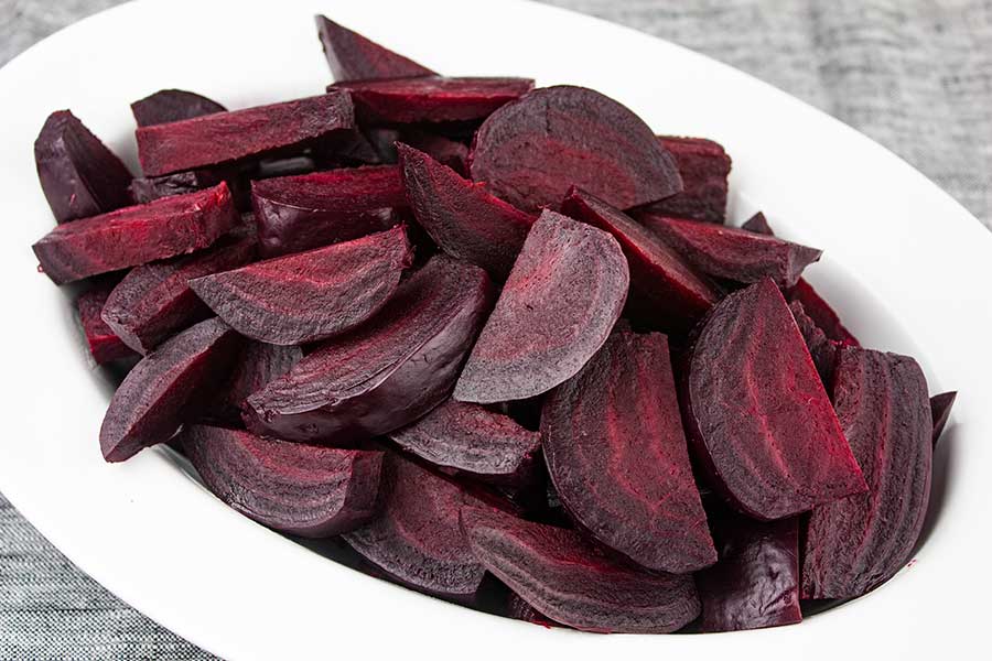 Ninja Foodi fresh beets in an oval white bowl.