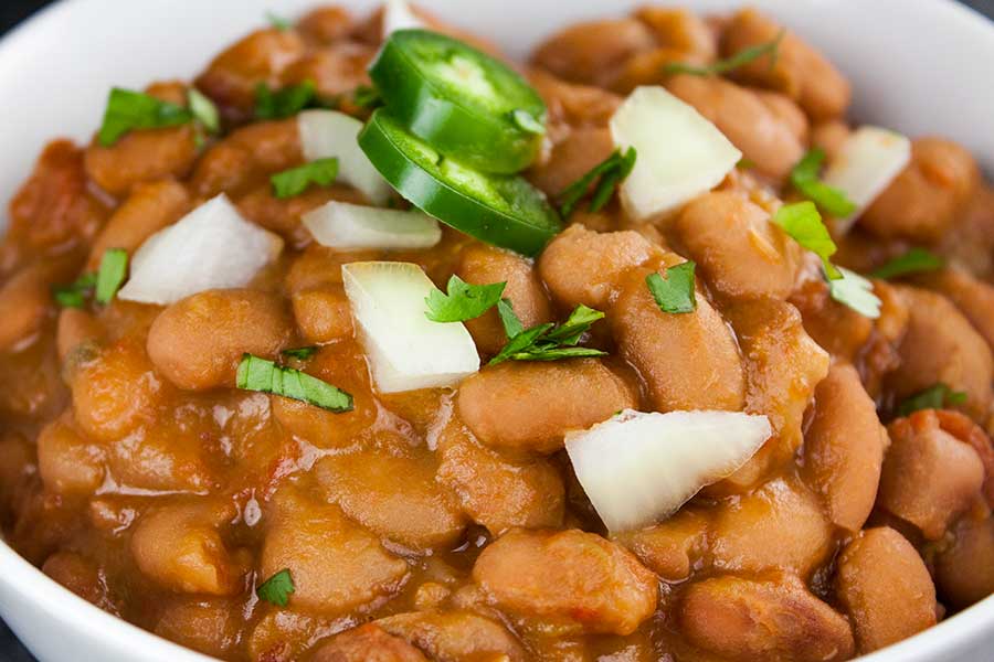 Mexican Pinto Beans (Charro Beans) - Such an easy recipe to spice up pinto beans. Perfect side dish to any Mexican meal! Hearty enough to be the main meal.