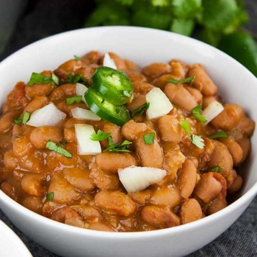 Ninja Foodi Mexican Pinto Beans (Charro Beans) - Such an easy recipe to spice up pinto beans. Perfect side dish to any Mexican meal! Hearty enough to be the main meal.