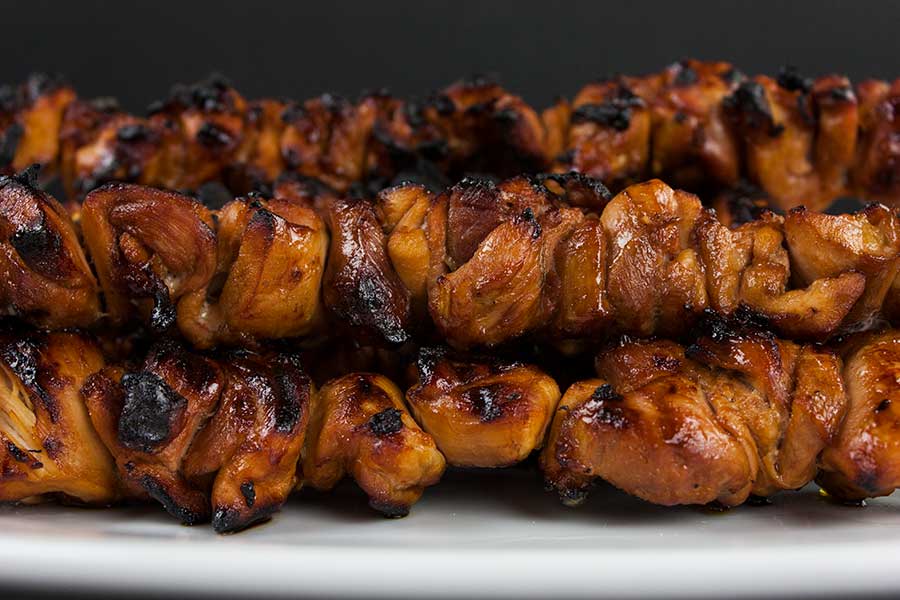 Filipino Chicken Kebabs on a white plate.