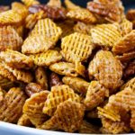 Praline Crunch Snack Mix in a white bowl.