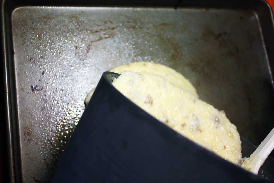 Fried Grit Cakes - grit mixture being poured into a sheet pan