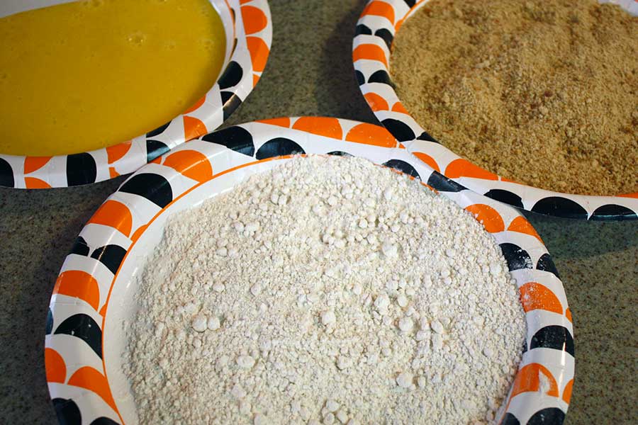 Fried Grit Cakes - flour, eggs, and bread crumbs on paper plates