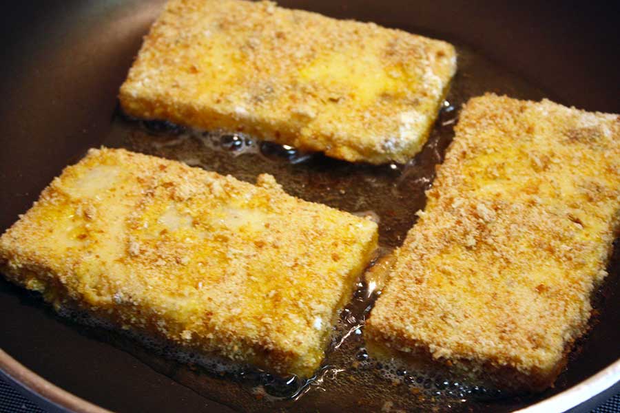 Fried Grit Cakes in a frying pan