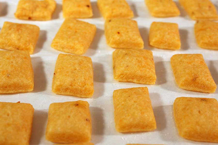 baked crackers on a parchment paper lined baking sheet