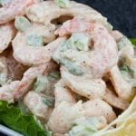 Shrimp Salad over lettuce leaves in a white bowl.