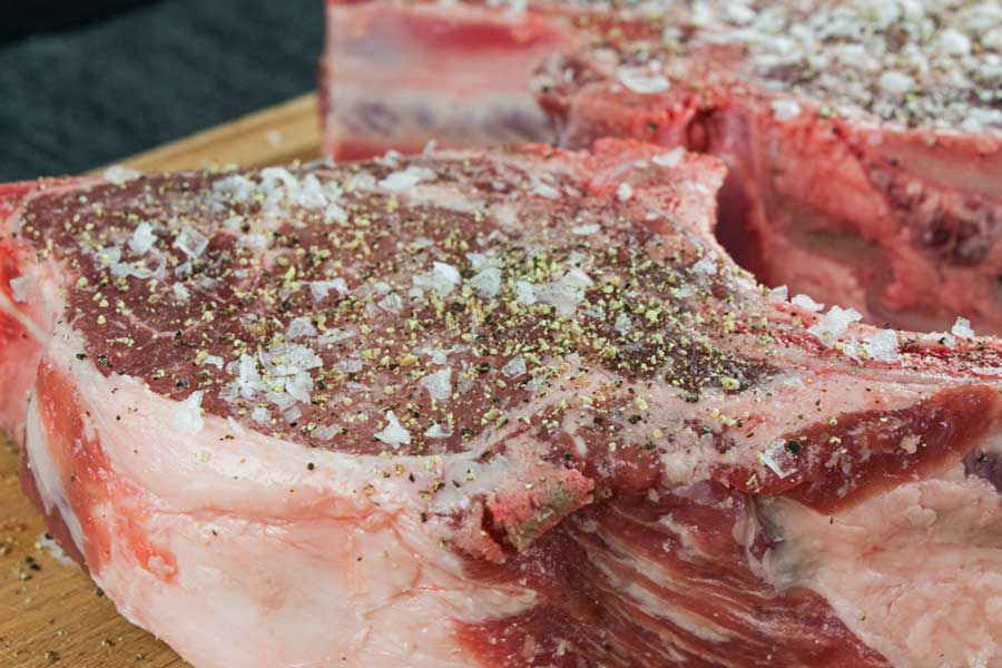 bone in pork chops, raw, with salt and pepper