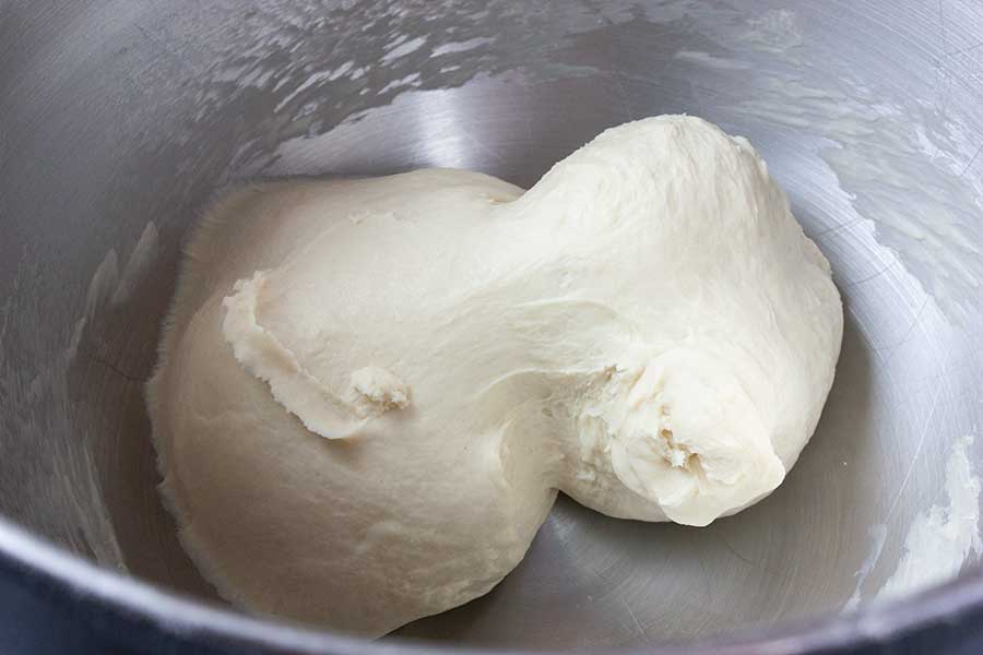 Bread dough in a mixer bowl.