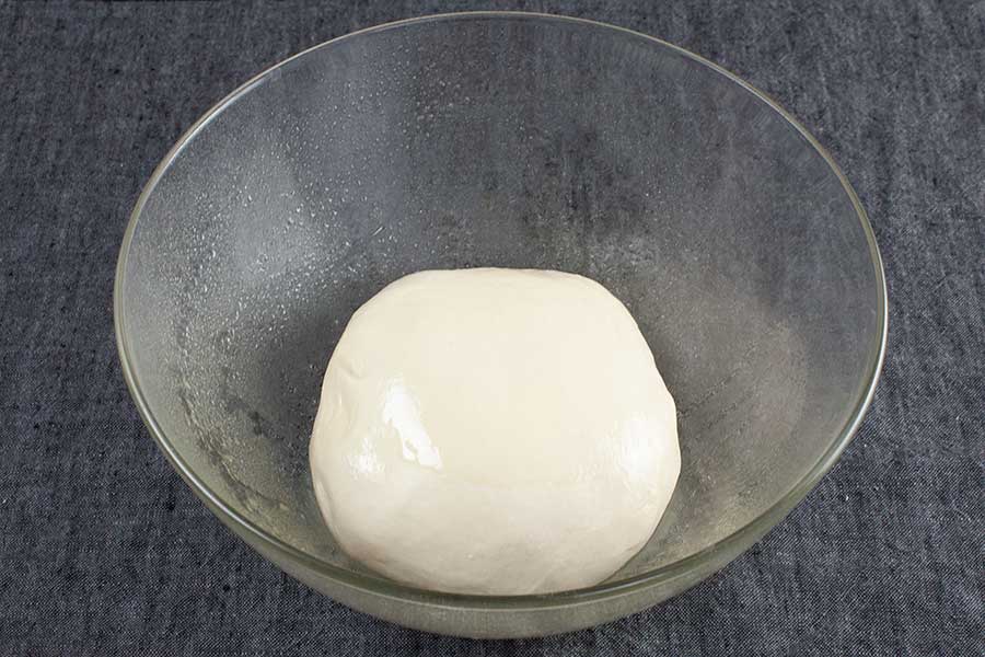 Bread dough in a glass bowl