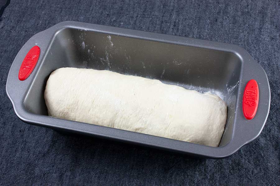Bread dough in a 9x5 baking pan.
