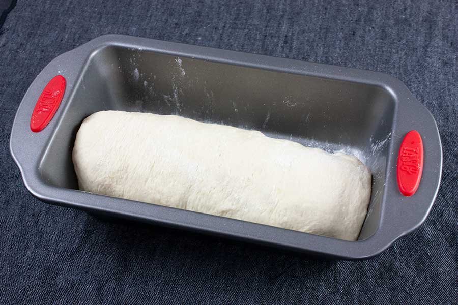 Bread dough in a 9x5 baking pan.