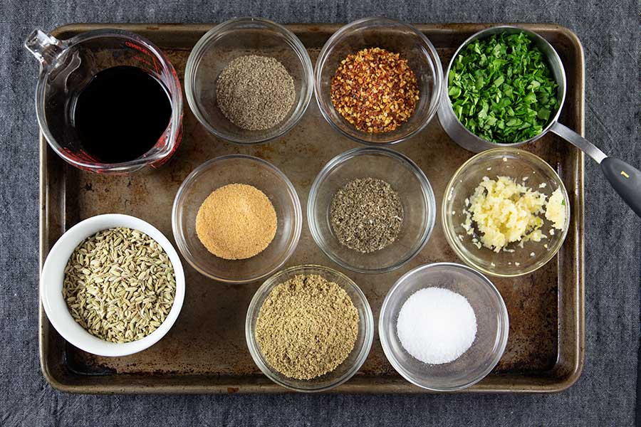 Prepared spices for the Italian Sausage in ramekins on a baking sheet.