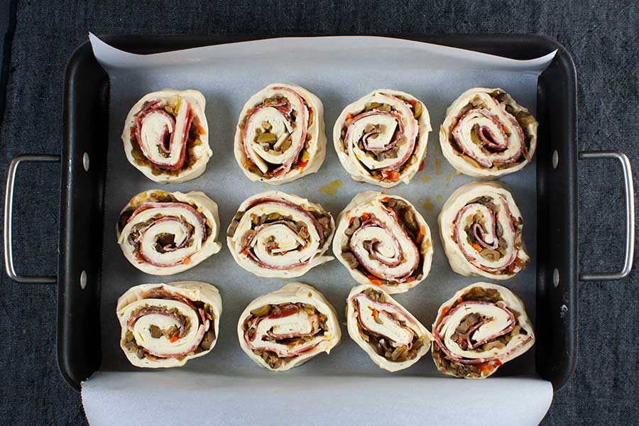 Muffuletta spirals. Cut into 12 equal shapes waiting to go into the oven