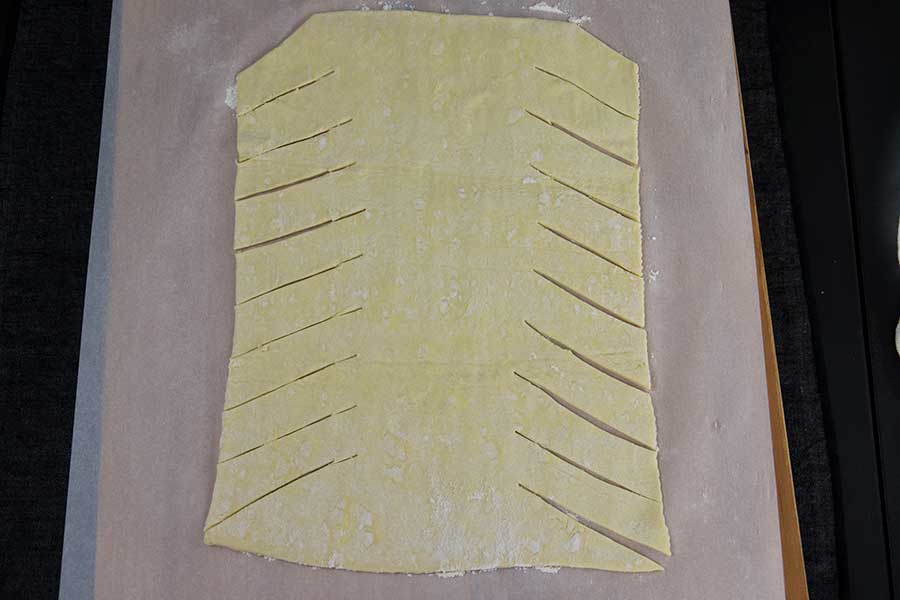 puff pastry laid out on parchment paper and cut