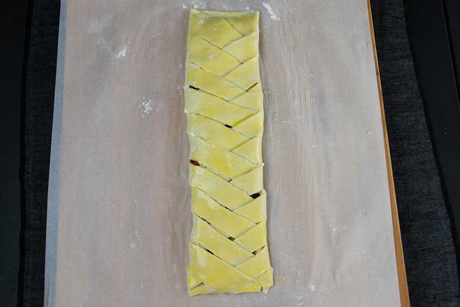 Raspberry Cream Cheese Danish - puff pastry braided on parchment paper