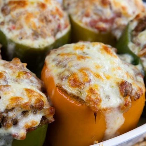 Stuffed bell peppers in a white baking dish.