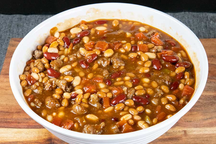 A bowl of various beans in a white bowl.