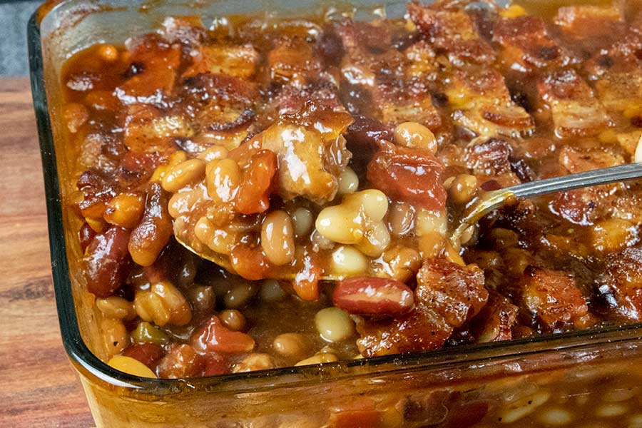 Cooked baked beans in a casserole dish.