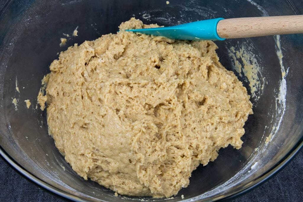 Dough combined in a glass bowl.