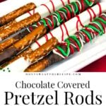 Chocolate covered pretzel rods on a light colored oblong plate.