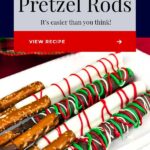 Chocolate covered pretzel rods on a light colored oblong plate.