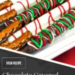 Chocolate covered pretzel rods on a light colored oblong plate.