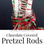 Chocolate covered pretzel rods in a mason jar wrapped in ribbon.