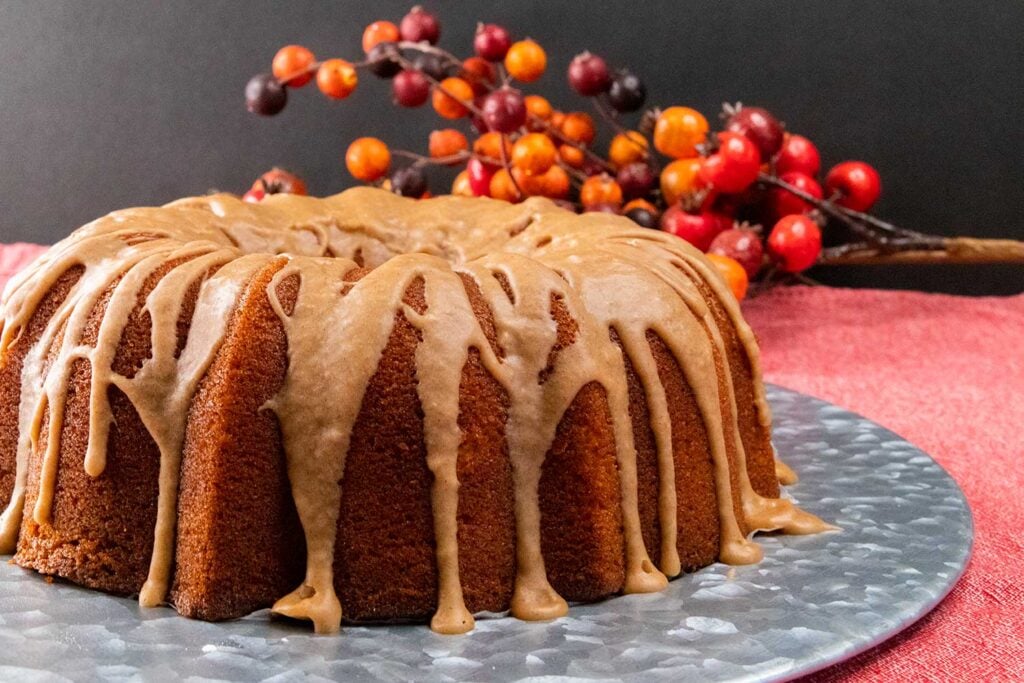 apple cider pound cake on a silver charger.