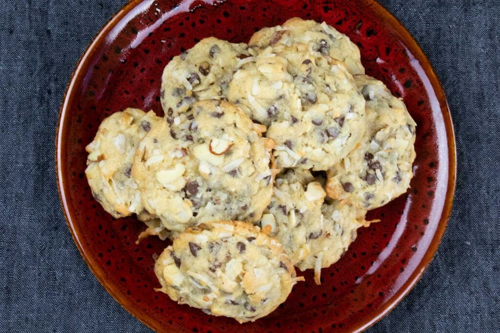 Almond joy cookies on red plate.