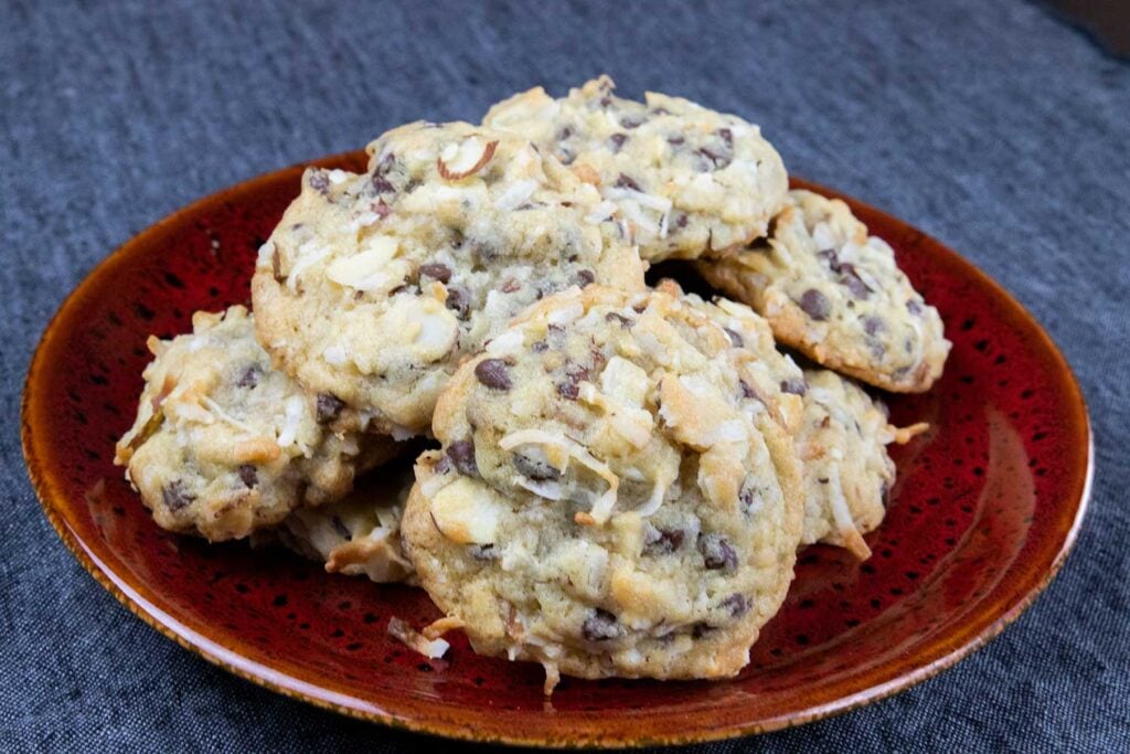 Almond joy cookies on red plate.