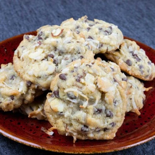 Almond joy cookies on red plate.