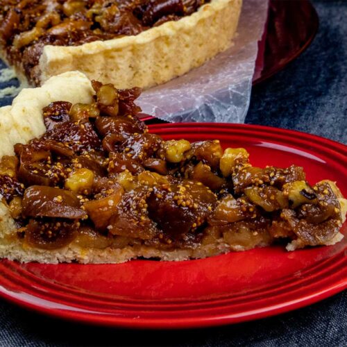 slice of fig tart on red plate