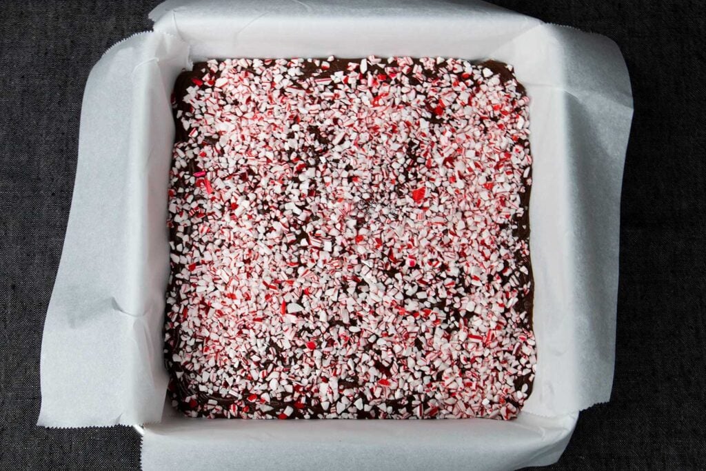 Peppermint fudge in a lined baking pan.