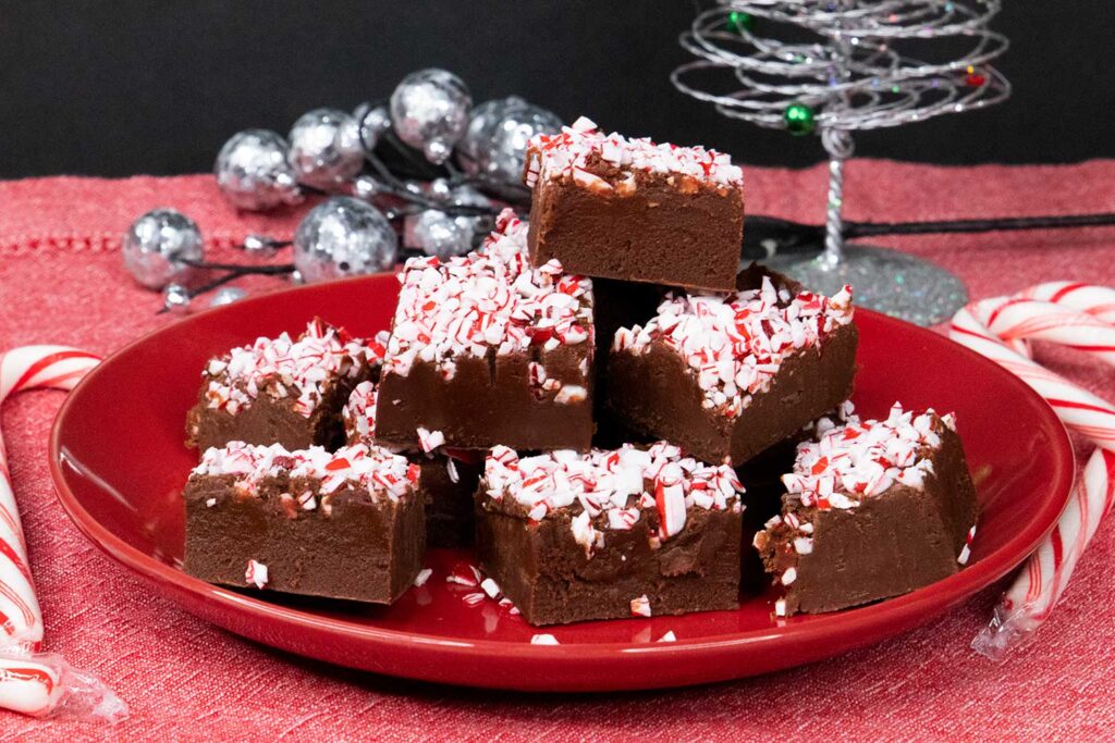 Peppermint fudge slices on red plate.