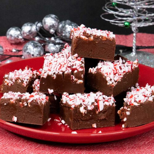 Peppermint fudge slices on red plate.