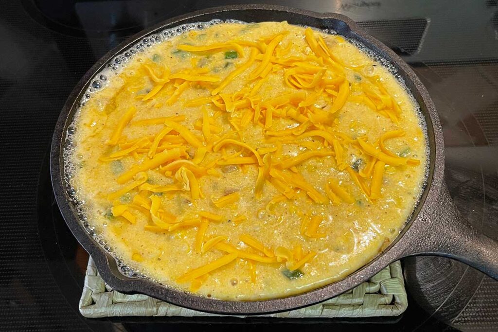 Uncooked cornbread in a cast iron skillet