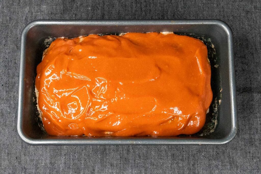 meatloaf covered with sauce in loaf pan